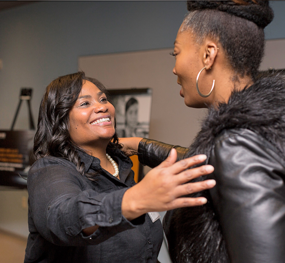 Dec. 6, 2017: LiveWire “Homework without a home: Helping homeless students in Seattle”: Tyra Williams, McKinney-Vento liaison/program manager at Seattle Public Schools, greets Nichelle Page, school district representative on the Equity and Social Justice Commission, City of Tukwila.